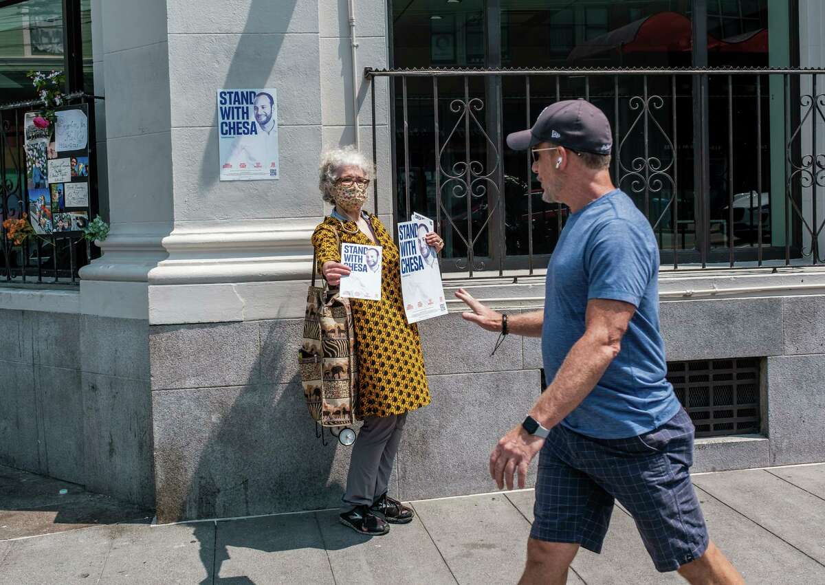 Cameron Galloway tries to speak with passersby in support of recall target Chesa Boudin.