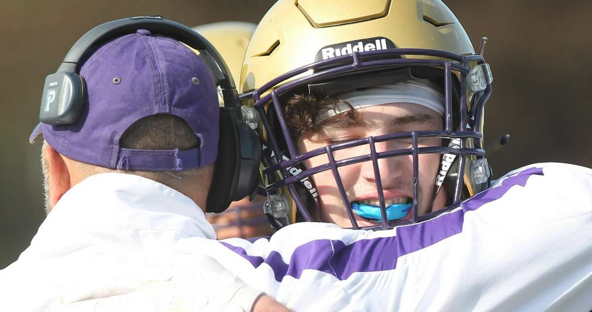 Routt's Braden Cors embraces Routt coach Barry Creviston after Cors scored on a 60-yard pass play in Routt's final game this season.
