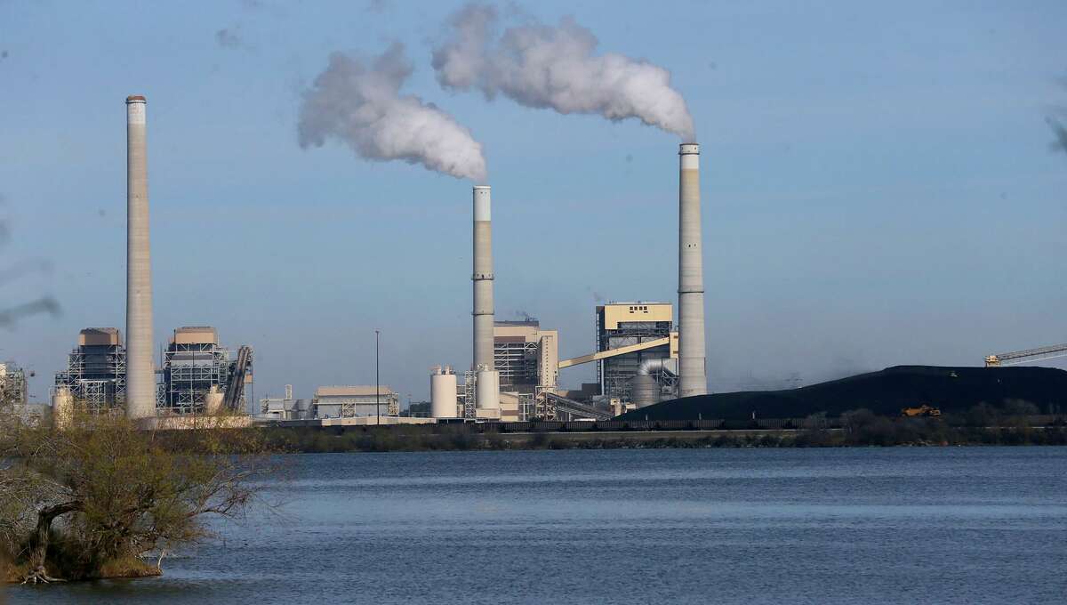 CPS Energy's coal-fired power plants J.K. Spruce, right and middle smoke stacks, and Deely on Calaveras Lake in January 2018. The Deely plant has since been retired.