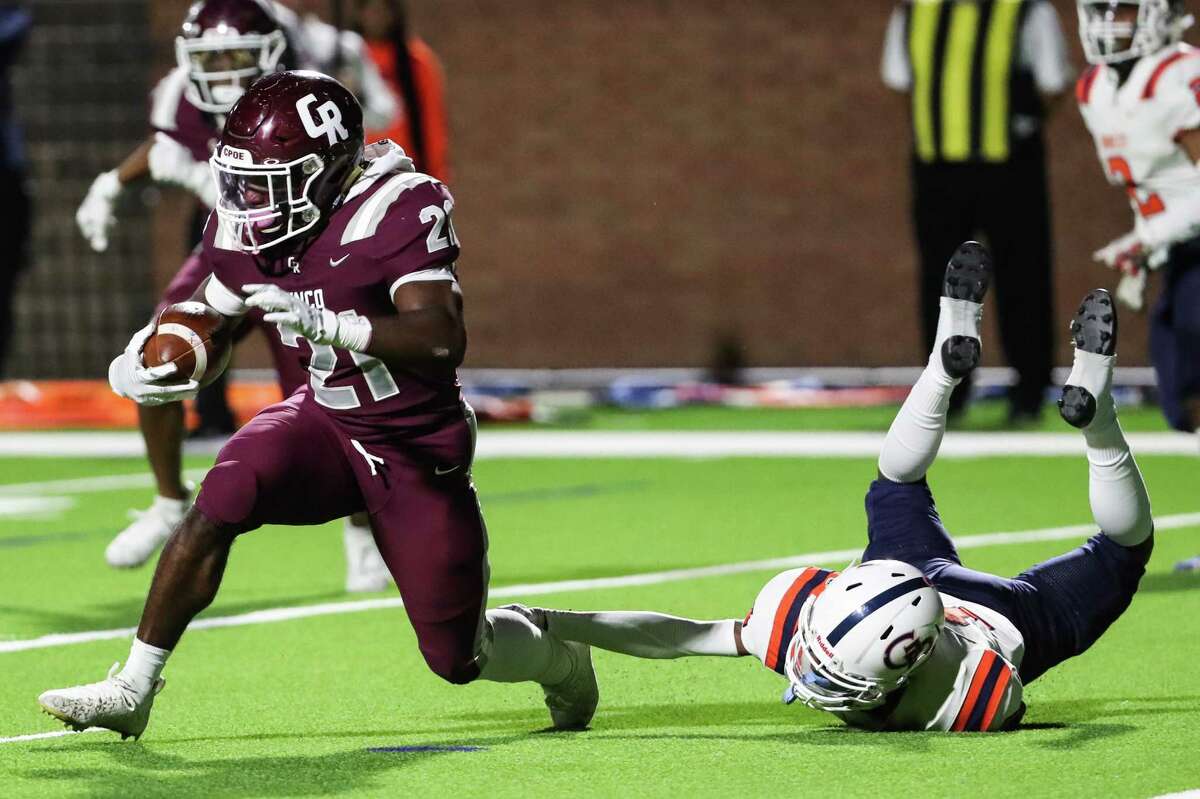 Cinco Ranch defensive back Odera Nsobundu (21) breaks away from George Bush’s Jamon Cooley (11) as he returns an interception out of the end zone during a Class 6A Division II bi-district high school football playoff game Friday, Nov. 12, 2021 in Houston.
