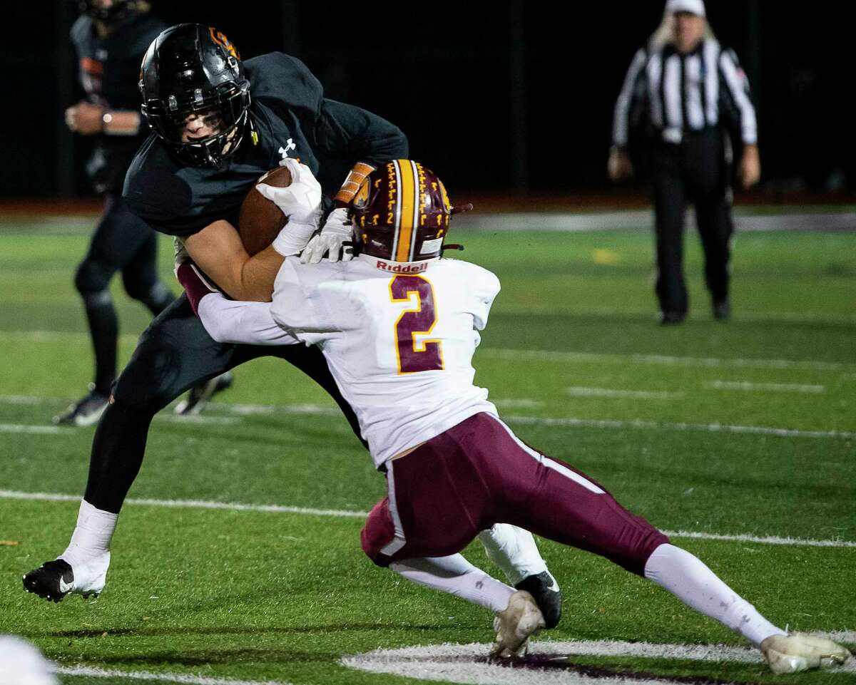 Fonda defensive back Roger Boyer tackles Schuylerville running back Lukas Sherman during the Class C Sectional Final at Lansingburgh High School in Troy on Friday.