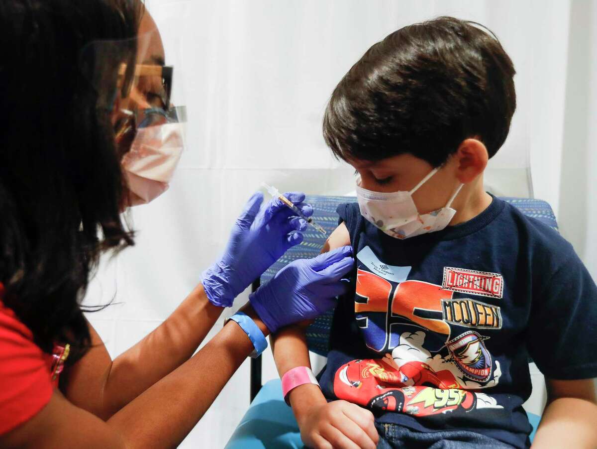 Kimberly Jones, left, gives six-year-old Chase Venketramen his first dose of the Pfizer COVID-19 vaccine at Texas Children’s Hospital The Woodlands, Tuesday, Nov. 9, 2021, in The Woodlands.
