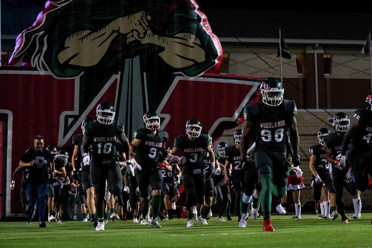 The Woodlands football team runs onto the field before a Class 6A Division I bi-district playoff game Friday, Nov 12, in Shenandoah.