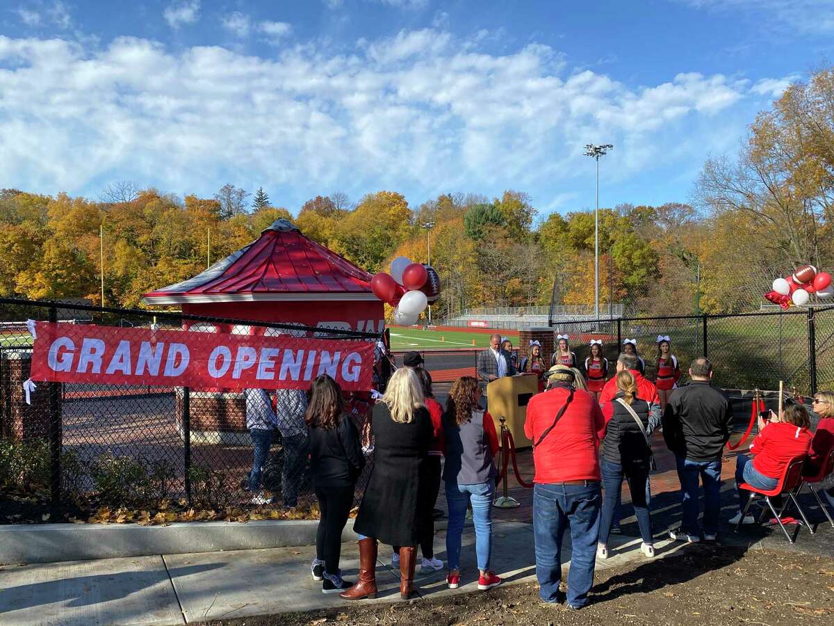 Board of Education member and Committee Liaison Joe Kelly cuts the ribbon for the official grand reopening of Cardinal Stadium at Greenwich High School Saturday, Nov. 13, 2021.
