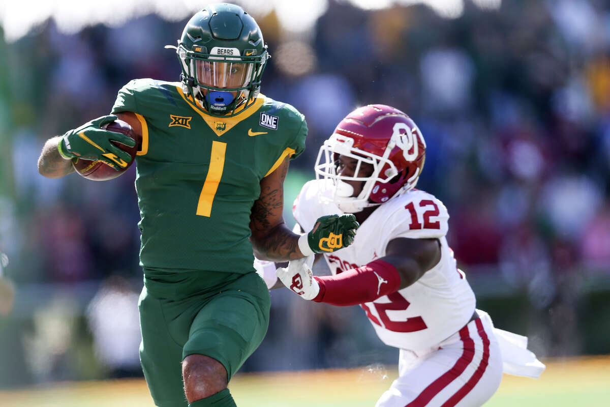 Oklahoma defensive back Key Lawrence (12) pushes Baylor running back Trestan Ebner (1) out of bounds during a NCAA football in Waco, Texas on Saturday, Nov. 13, 2021. (Ian Maule/Tulsa World via AP)