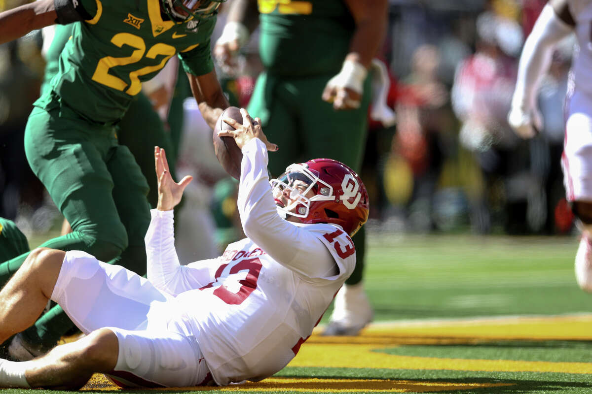 Oklahoma quarterback Caleb Williams (13) bobbles the ball while falling into the end zone against Baylor during a NCAA football in Waco, Texas on Saturday, Nov. 13, 2021. (Ian Maule/Tulsa World via AP)