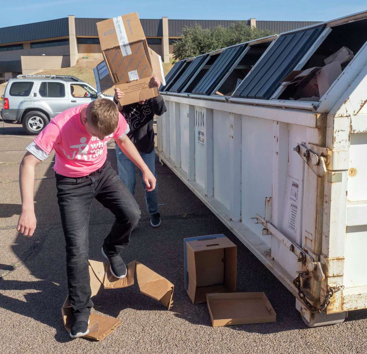 Volunteers help unload residents cars and trucks of recyclable items 11/13/2021 during the 16th annual Texas Recycles Day with Keep Midland Beautiful in the parking lot on Midland College campus. Tim Fischer/Reporter-Telegram