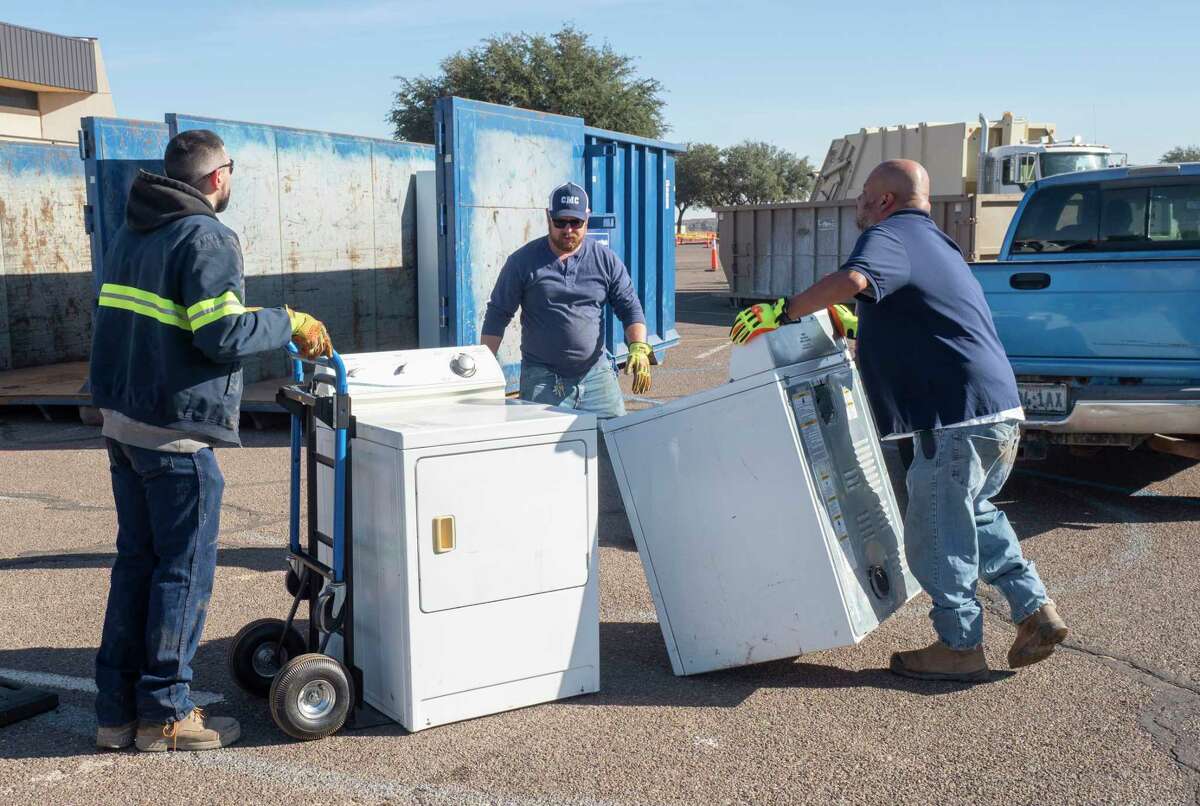 Volunteers help unload residents cars and trucks of recyclable items 11/13/2021 during the 16th annual Texas Recycles Day with Keep Midland Beautiful in the parking lot on Midland College campus. Tim Fischer/Reporter-Telegram