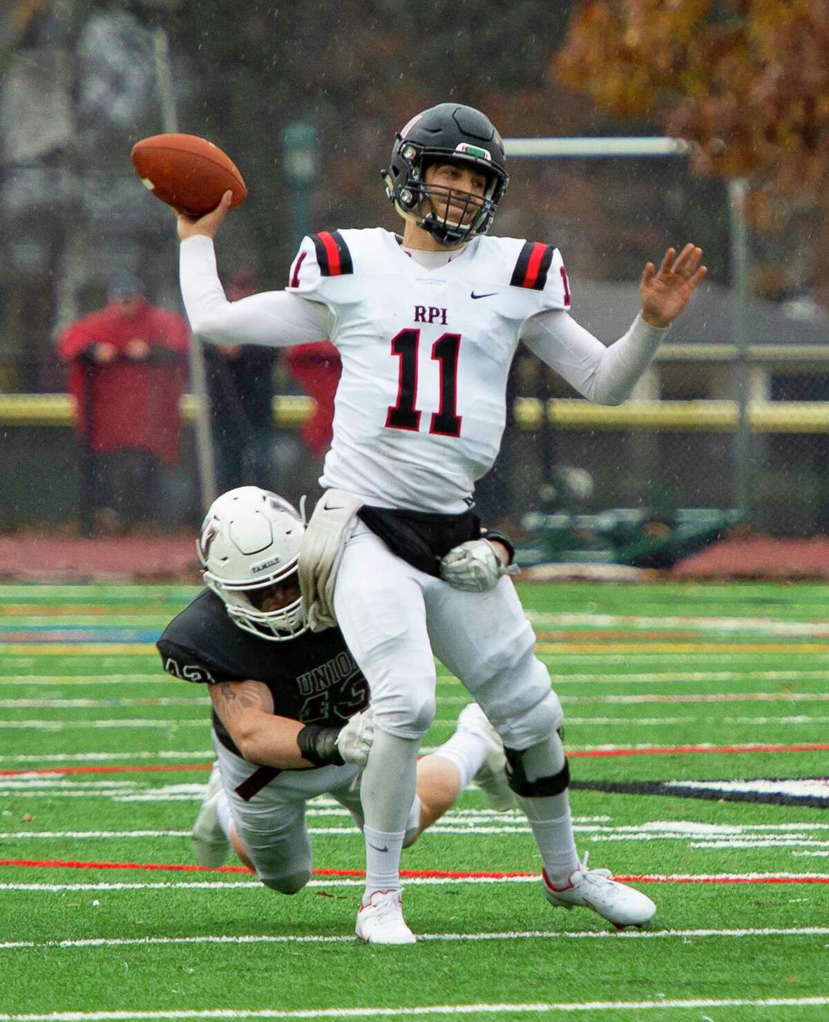 RPI quarterback George Marinopoulis throws the ball as is brought down by Union linebacker Colin Lama during the Dutchman Shoes game at Union College in Schenectady, N.Y., Saturday, Nov. 13, 2021. (Jenn March, Special to the Times Union)