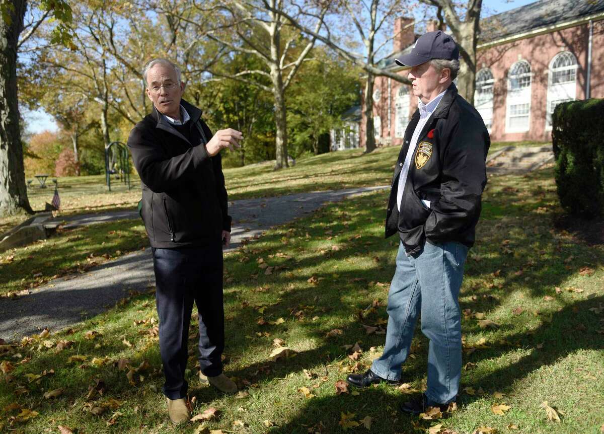 Chair of Rink User Committee for Design and Planning Bill Drake, left, and Byram veteran Dave Wolg speak at Eugene Morlot Memorial Park in the Byram section of Greenwich, Conn. Wednesday, Nov. 10, 2021. The plan to build a new ice rink in Byram is running into a challenge because of a desire to protect a park that's next to it, which has served for decades as a memorial to local veterans.