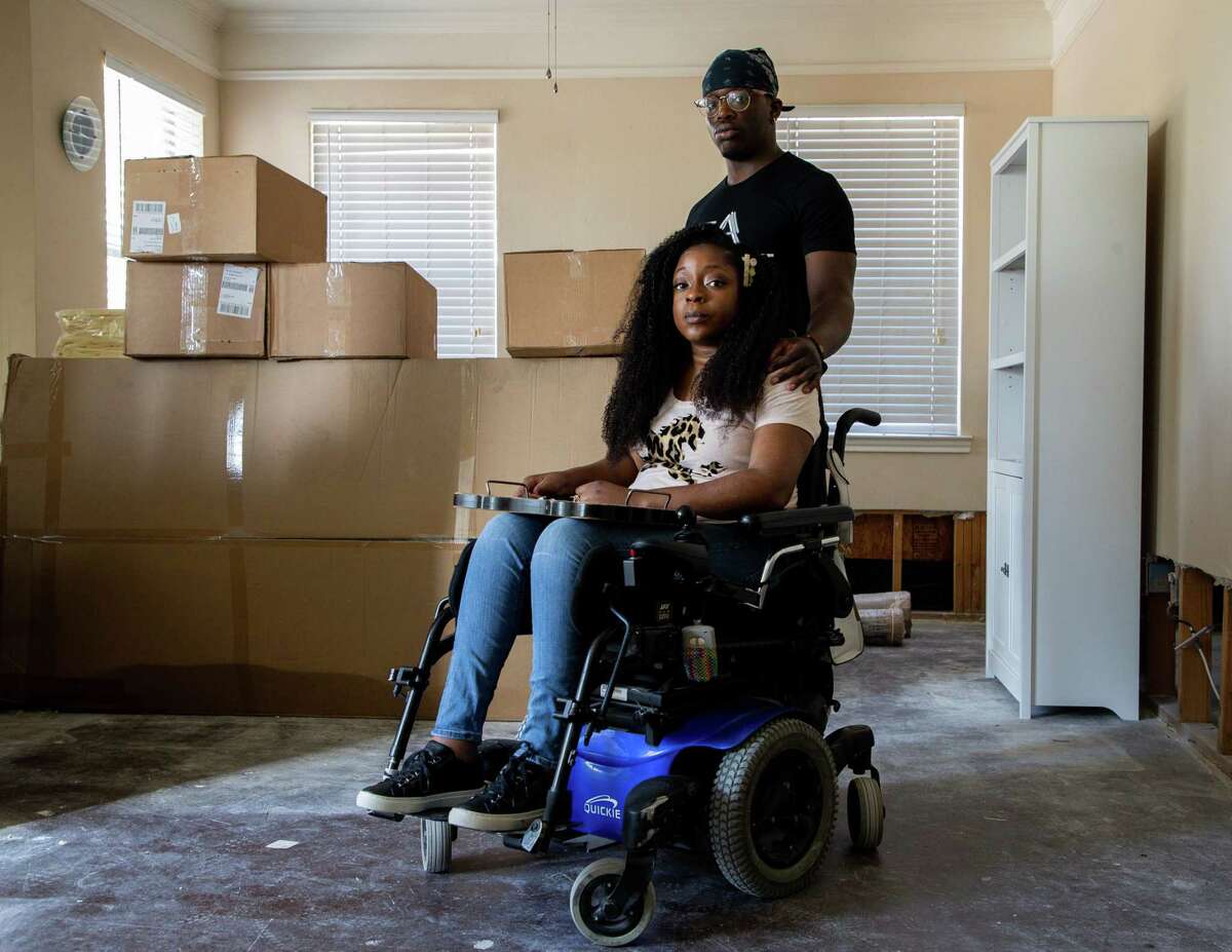 Kemi Yemi-Ese and Femi - her younger brother - pose for a photograph inside her apartment on Thursday, April 1, 2021, in Austin, Texas. Yemi-Ese is paralyzed and had a tough experience in the winter storm. The storm revealed serious problems in how Texas takes care of medically fragile residents.