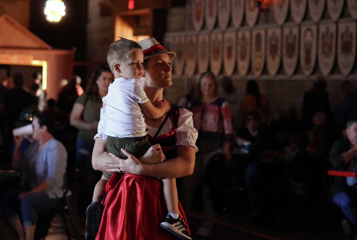 Saskia Toth and her son Leighton listen to the Cloverleaf Orchestra during Wurstfest in New Braunfels on Saturday.