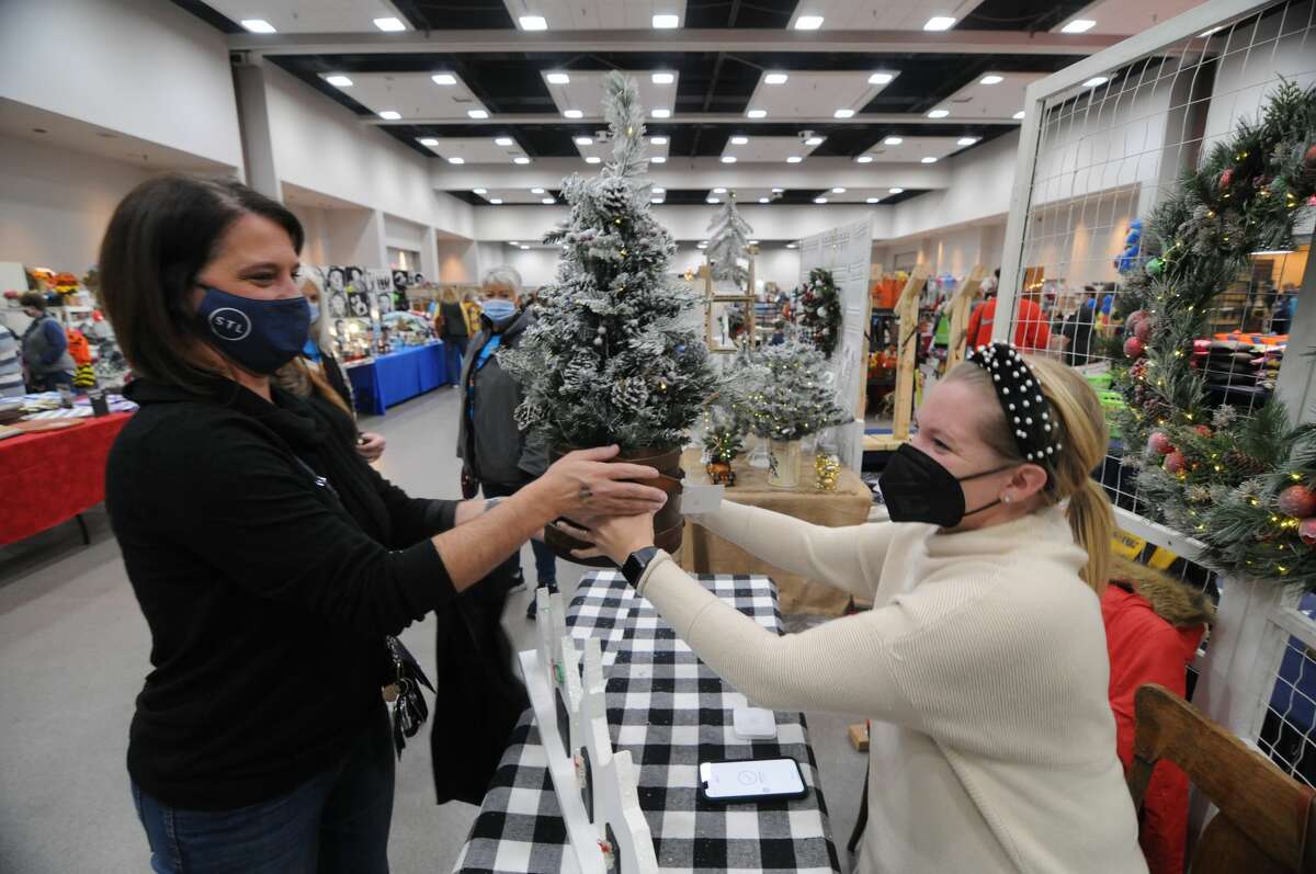 Melissa McCarthy of St. Louis purchases a tree from Jamie Boston of Carlinville during the 28th Annual Craft Fair for the Edwardsville High School Marching Tigers at the Gateway Center in Collinsville. About 5,000 people attended the event.