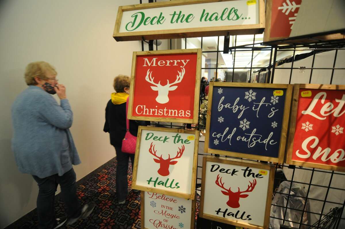Shoppers walk by holiday wares during the Edwardsville Marching Tigers Craft Fair.