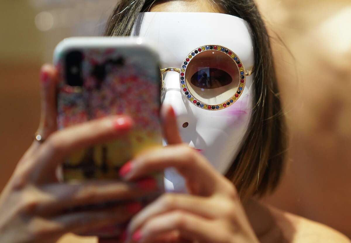 Masked models were part of the Plastic Humanity exhibition at Hemisfair.