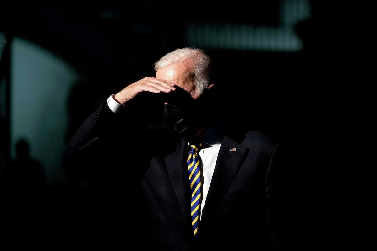 President Joe Biden shades his eyes as walks towards reporters as he departs the White House in Washington on Friday, Nov. 12, 2021, for Camp David in Maryland where he is scheduled to spend the weekend. (Stefani Reynolds/The New York Times)