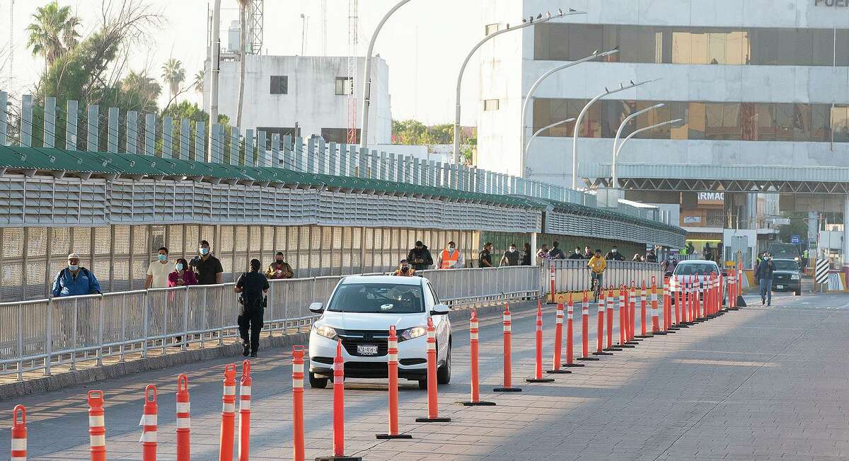 Pedestrians and motorists travel to the United States from Mexico Monday, Nov. 8, 2021, through Gateway to the Americas International Bridge as the U.S. allows non-essential travel into the country for vaccinated visitors.