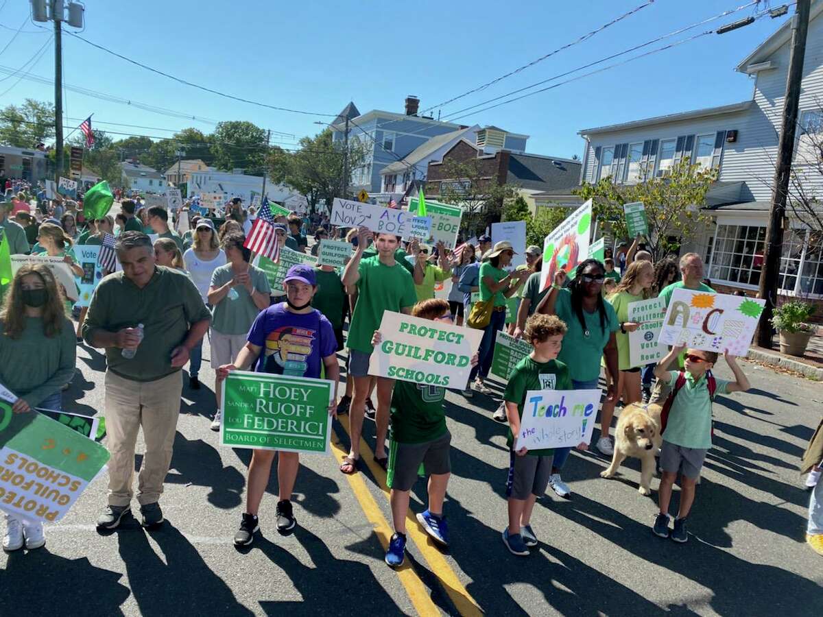 Democratic Party supporters, including Guilford Voices for Unity and Equity members, march in a parade for the Guilford Fair on Saturday, Sept. 18, 2021.