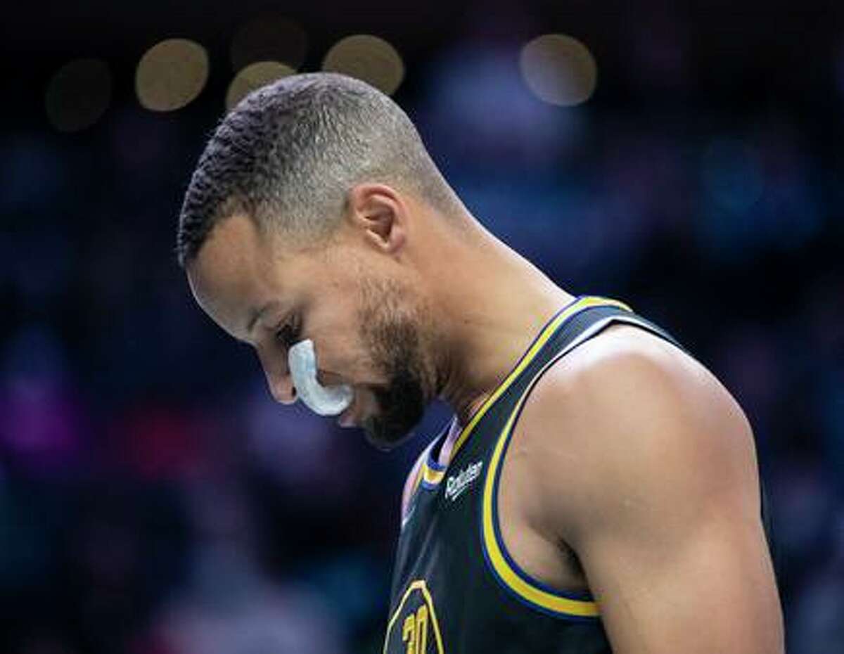 Golden State Warriors guard Stephen Curry (30) takes a moment prior to an NBA basketball game against the Charlotte Hornets, Sunday, Nov. 14, 2021, in Charlotte, N.C. (AP Photo/Matt Kelley)