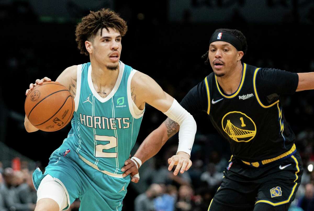 Hornets guard LaMelo Ball drives past Damion Lee during the second quarter at Spectrum Center. Ball finished with 21 points, five assists and seven rebounds.