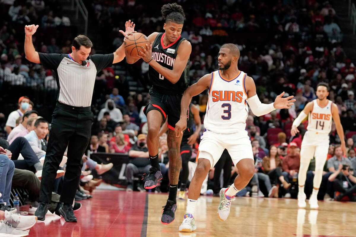 Houston Rockets guard Jalen Green, center, tries to save the ball from going out of bounds as Phoenix Suns guard Chris Paul (3) defends during the second half of an NBA basketball game, Sunday, Nov. 14, 2021, in Houston. (AP Photo/Eric Christian Smith)