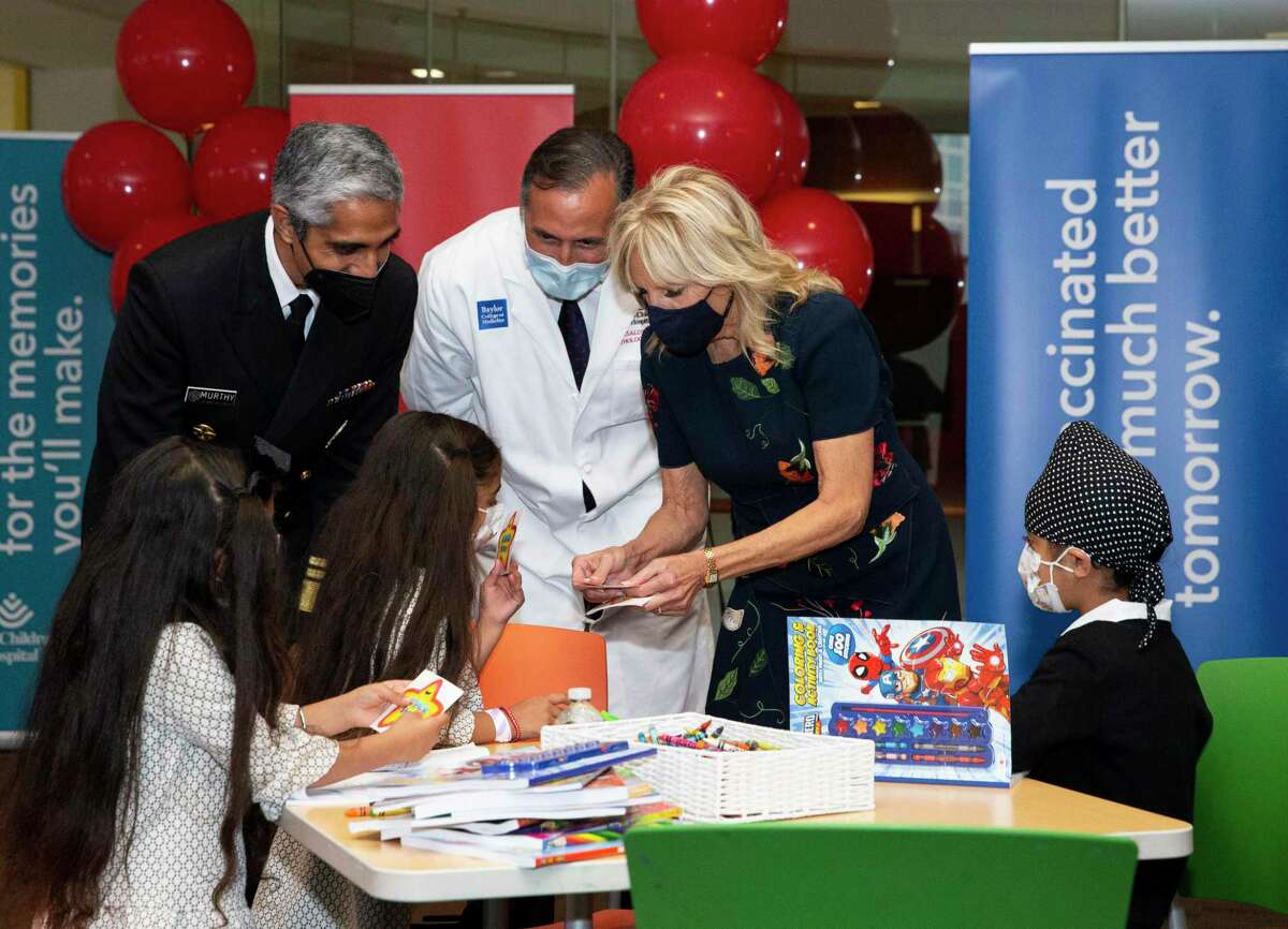 First Lady Jill Biden hands out stickers to five-year-old triplets Sahiba Singh, from left, Sohaila Singh and Zorawar Singh during her visit at a pediatric COVID-19 vaccination clinic Sunday, Nov. 14, 2021, at Texas Children's Hospital in Houston. Visiting with her were U.S. Surgeon General Dr. Vivek Murthy, back left, and Dr. James Versalovic. Biden and Murthy encouraged parents and guardians to vaccinate kids ages 5-11.