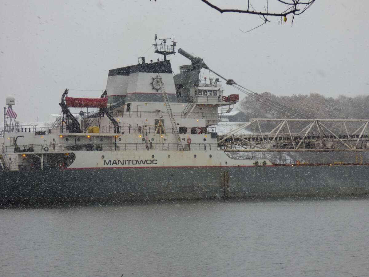 The freighter Manitowoc arrives on Manistee Lake under heavy snowfall Sunday.