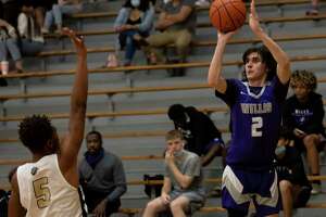 Willis shooting guard Tanner Davis (2) shoots for a 3-pointer passed Conroe Rashaad Salih (5) during the second quarter of a District 13-6A boys basketball game in The Pit at Conroe High School on Tuesday, Feb. 9, 2021, in Conroe.