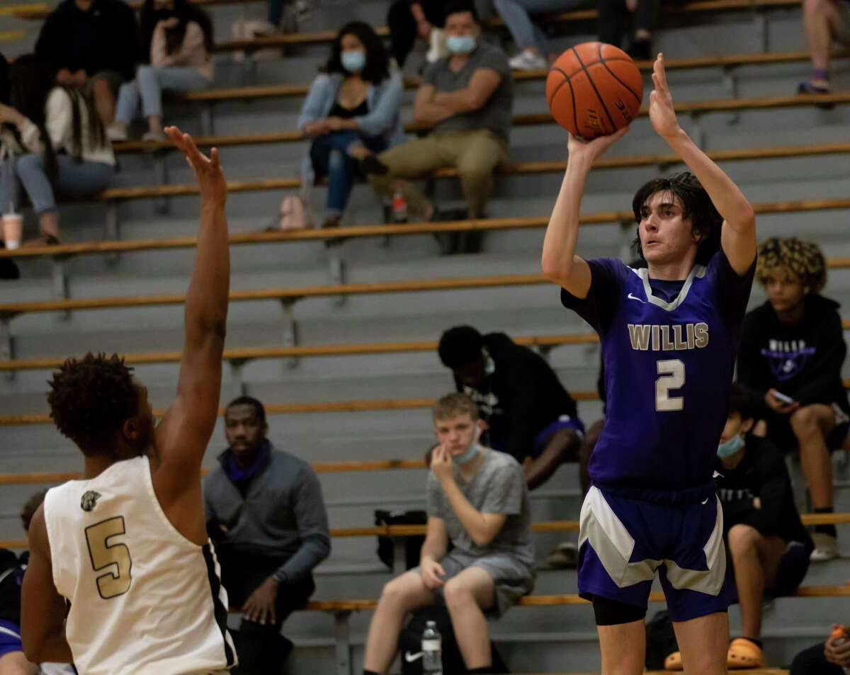 Willis shooting guard Tanner Davis (2) shoots for a 3-pointer passed Conroe Rashaad Salih (5) during the second quarter of a District 13-6A boys basketball game in The Pit at Conroe High School on Tuesday, Feb. 9, 2021, in Conroe.
