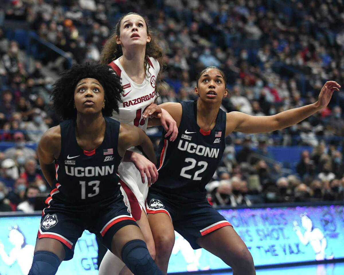 UConn guards Christyn Williams (13) and Evina Westbrook (22) box out a defender in UConn’s season-opening 95-80 win over Arkansas in November.