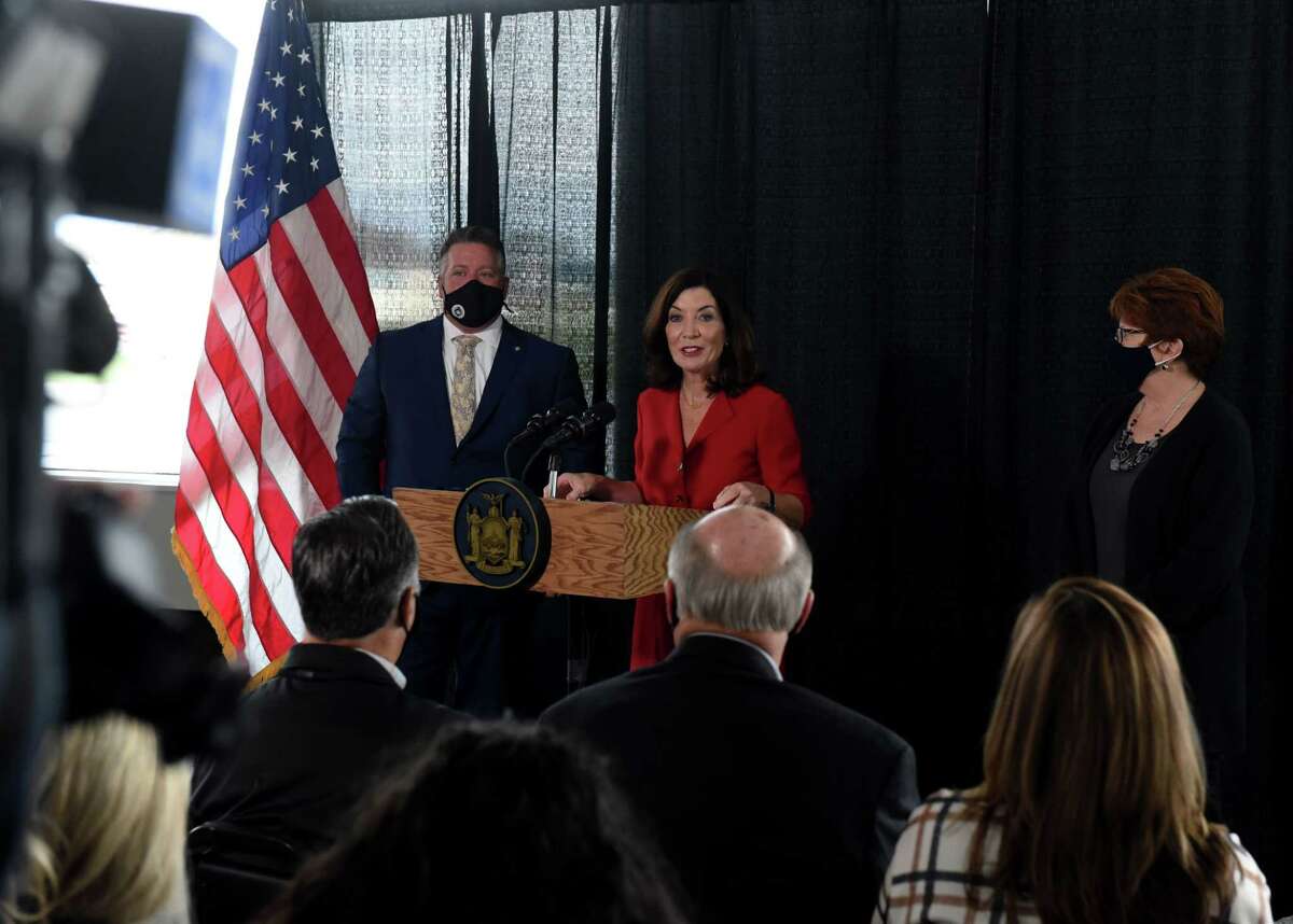 Gov. Kathy Hochul, center; joined by Albany County Executive Dan McCoy, left, and Albany Mayor Kathy Sheehan, right, announces an expected $28.7 million in federal funding for Albany International Airport on Monday, Nov. 15, 2021, during a press conference at the airport in Colonie, N.Y. The county airport is expected to receive $28.7 million in federal funding through the infrastructure bill. Money would be used to modernize the terminal, expand the airport?•s cargo facility and construction of a new aircraft hangar.