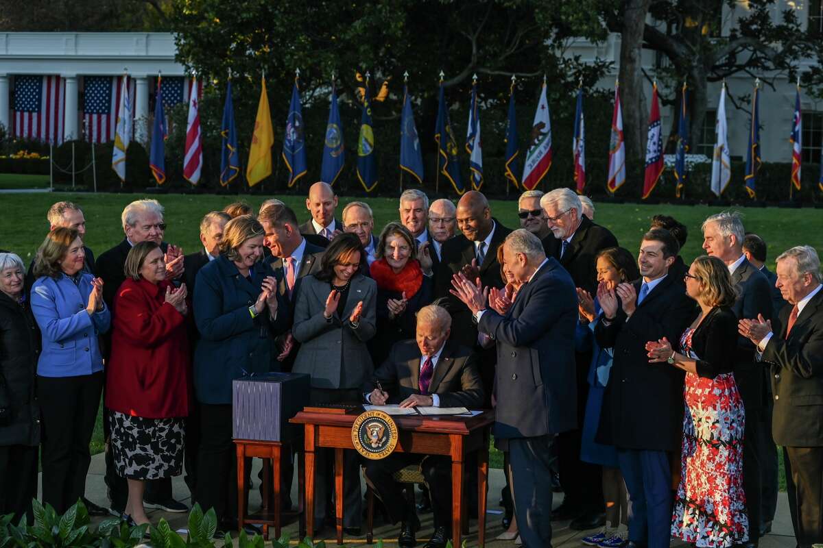 Joe Biden signs the $1 trillion bipartisan infrastructure bill November 15, 2021 in Washington, DC.