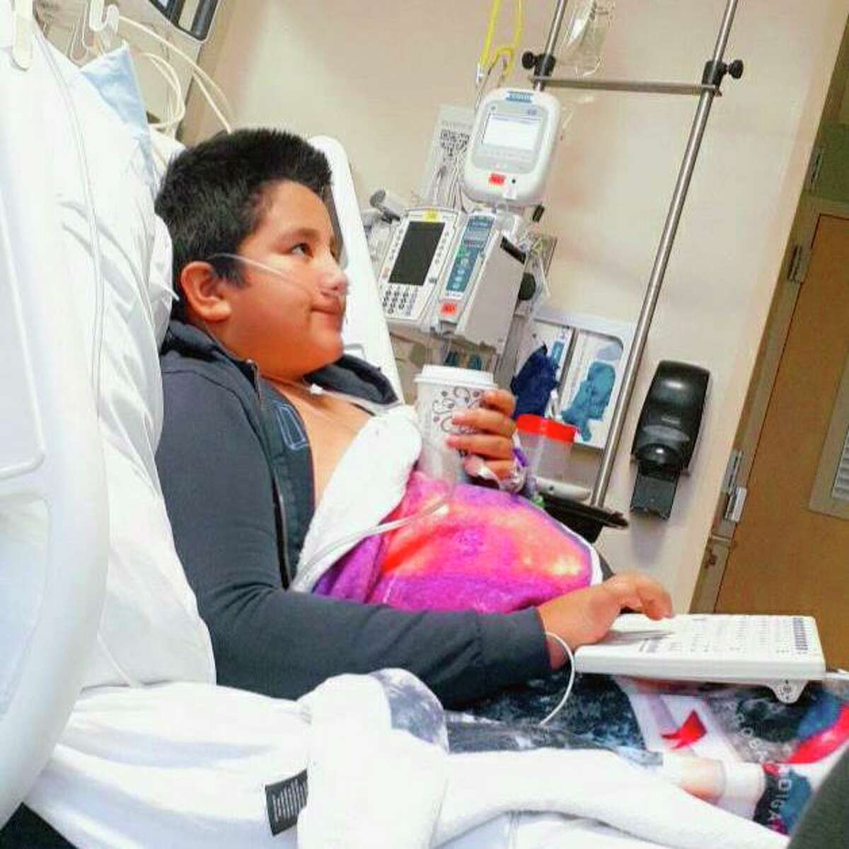This 2021 photo provided by Yessica Gonzalez shows her son, Francisco Rosales, 9, in the intensive care unit at Children’s Medical Center in Dallas, Texas. The day before he was supposed to start fourth grade, Francisco was admitted to the hospital due to severe COVID-19, struggling to breathe, with dangerously low oxygen levels and an uncertain outcome.
