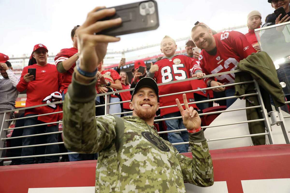 San Francisco 49ers' George Kittle takes a selfie with Jackson Walker, 8, of Hughson before Niners play Los Angeles Rams during NFL game at Levi's Stadium in Santa Clara, Calif., on Monday, November 15, 2021.