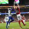 San Francisco 49ers' George Kittle catches a 1st quarter touchdown pass against Los Angeles Rams' Darious Williams during NFL game at Levi's Stadium in Santa Clara, Calif., on Monday, November 15, 2021.