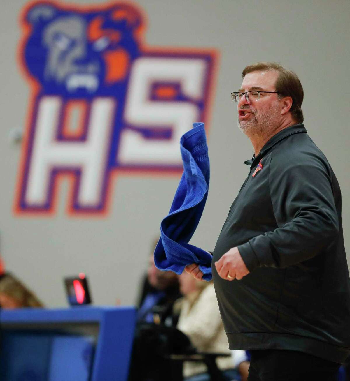 Grand Oaks head coach Mike Day waves a towel during the second quarter of a District 20-5A high school basketball game at Grand Oaks High School, Tuesday, Jan. 21, 2020, in Spring.