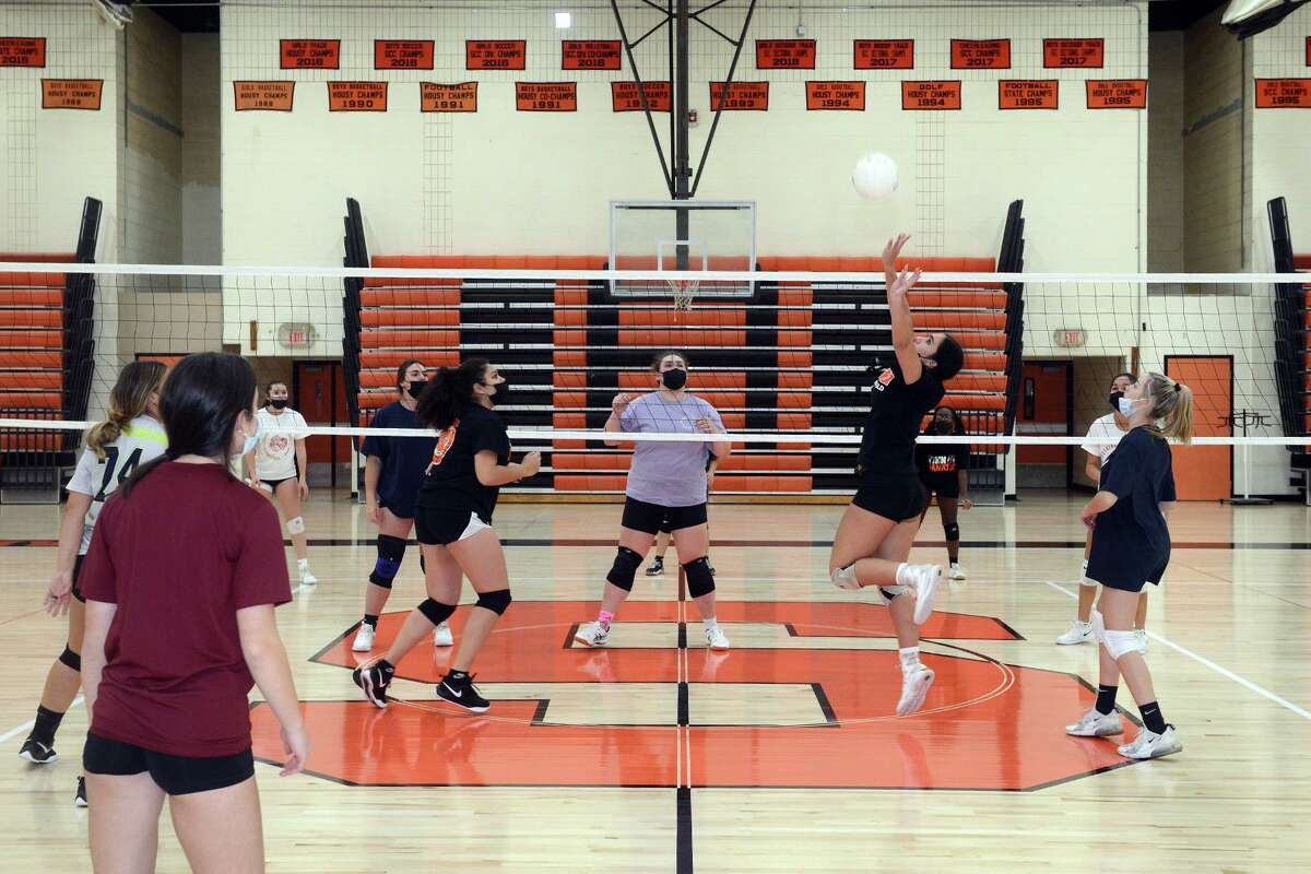 Members of the girls volleyball team practice on the new floor in the gym at Shelton High School on Nov. 15.