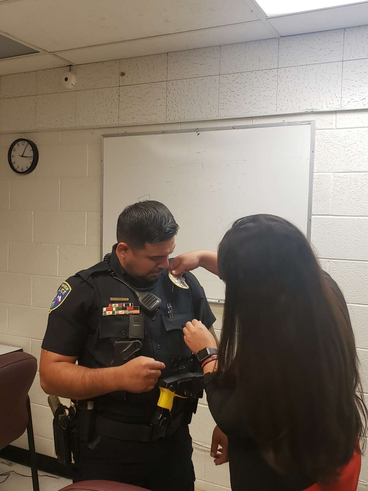 New Sergeant Jesse Ortiz is pinned by his wife, Brenda Diego, in a special ceremony commemorating his promotion. 