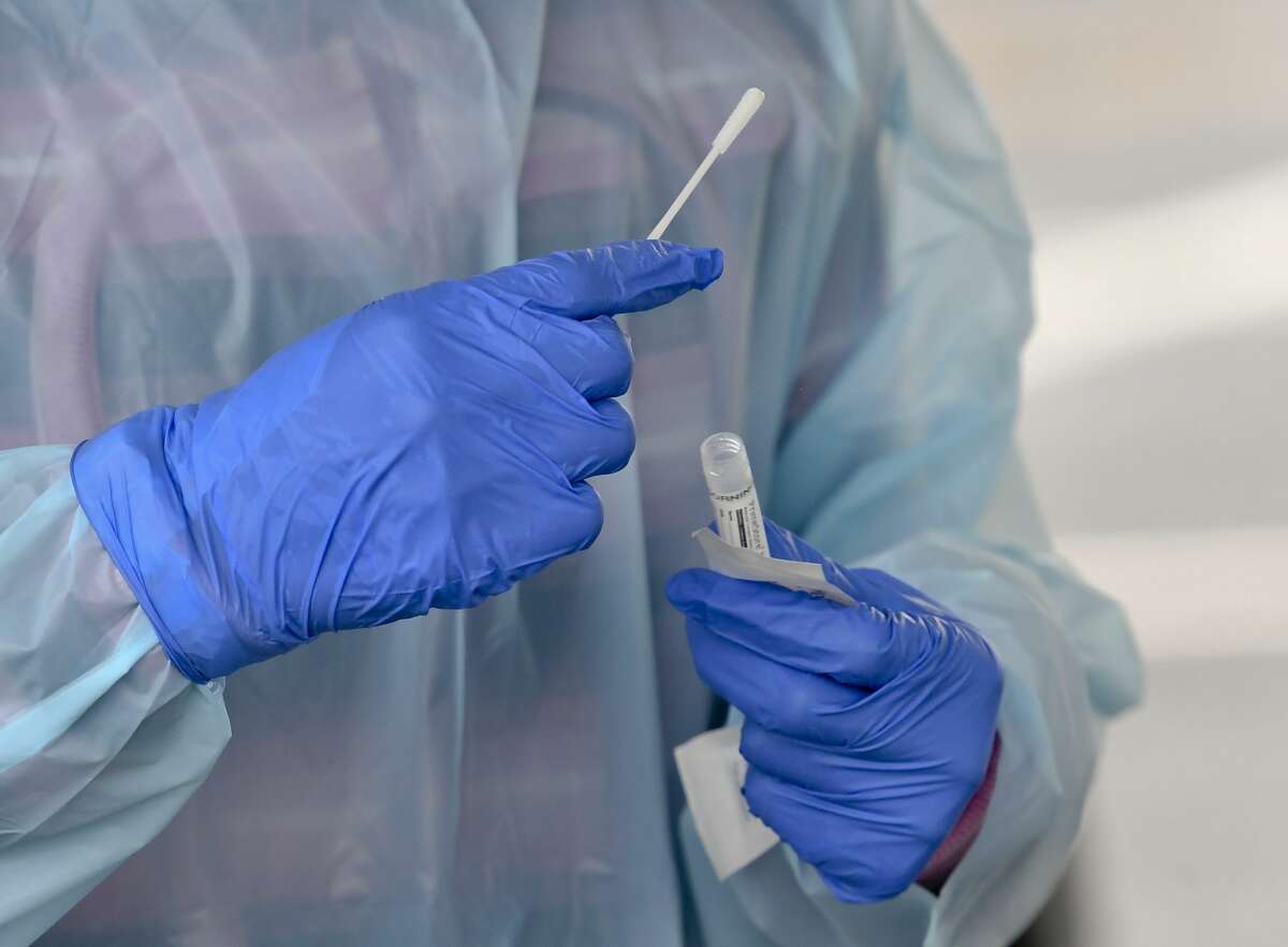 A nurse puts a swab into a vial after administering a COVID-19 test last year in Reading, Pennsylvania,