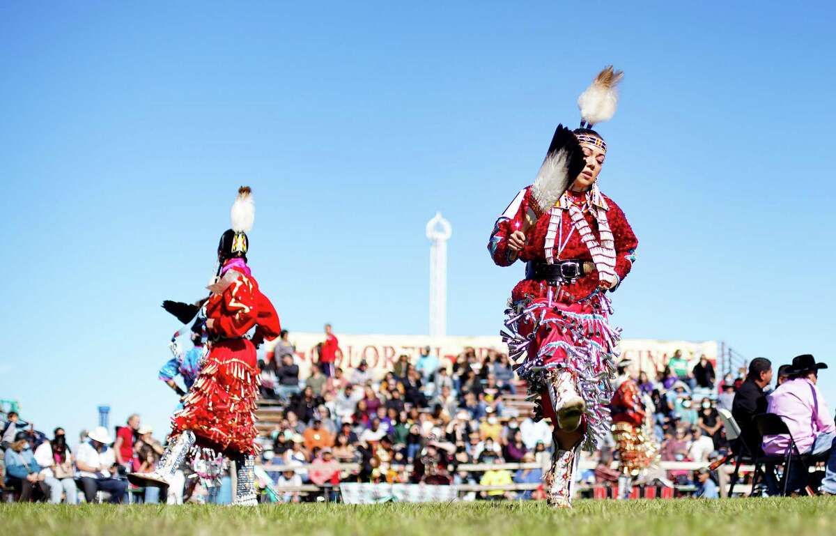 Jesenia Velez, right, competes during the jingle dance portion of the women’s all around competition during the 31st Annual Texas Championship Pow-wow at Trader’s Village on Saturday, Nov. 13, 2021 in Houston.