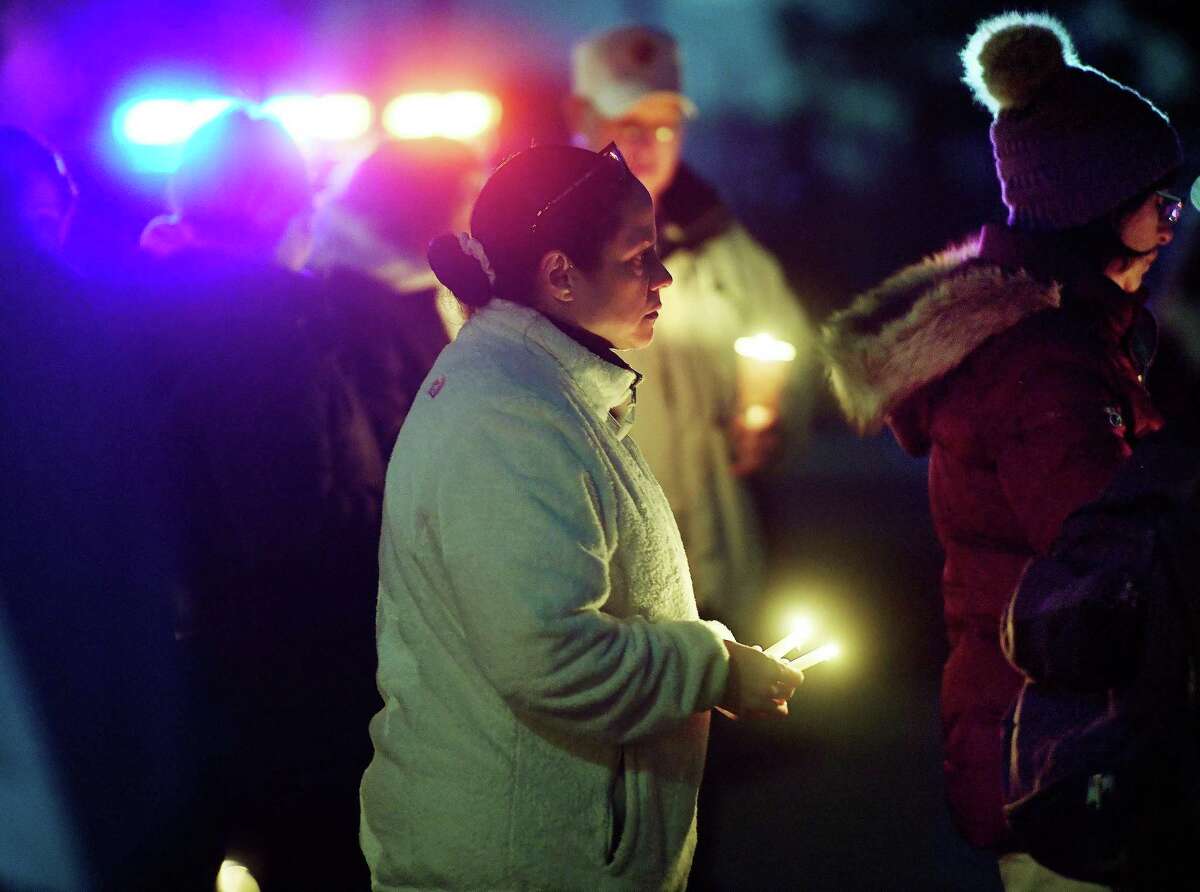 Friends, neighbors, and concerned citizens attend a candlelight vigil for domestic violence homicide victim Grace Zielinska outside her former home on Root Avenue in Ansonia, Conn. on Tuesday, November 16, 2021. Zielinska's husband, Kamil, has beern charged with murder in the case.