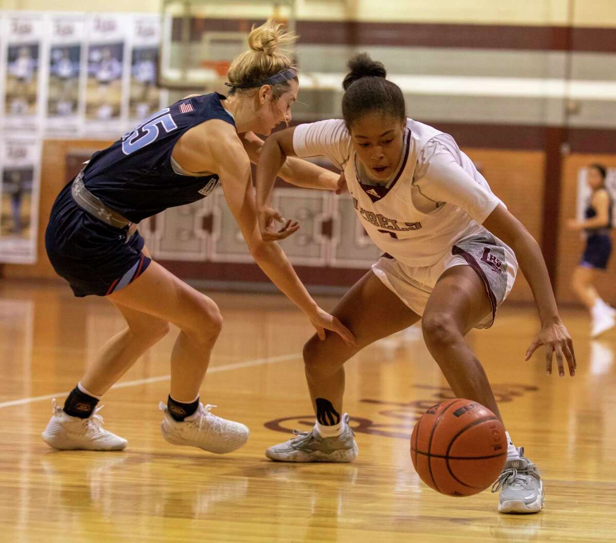 Legacy’s Sa'Nya Green steals the ball from Greenwood’s Karsyn Payton (15) on on Tuesday, Nov. 16, 2021 at Legacy High School. Jacy Lewis/Reporter-Telegram
