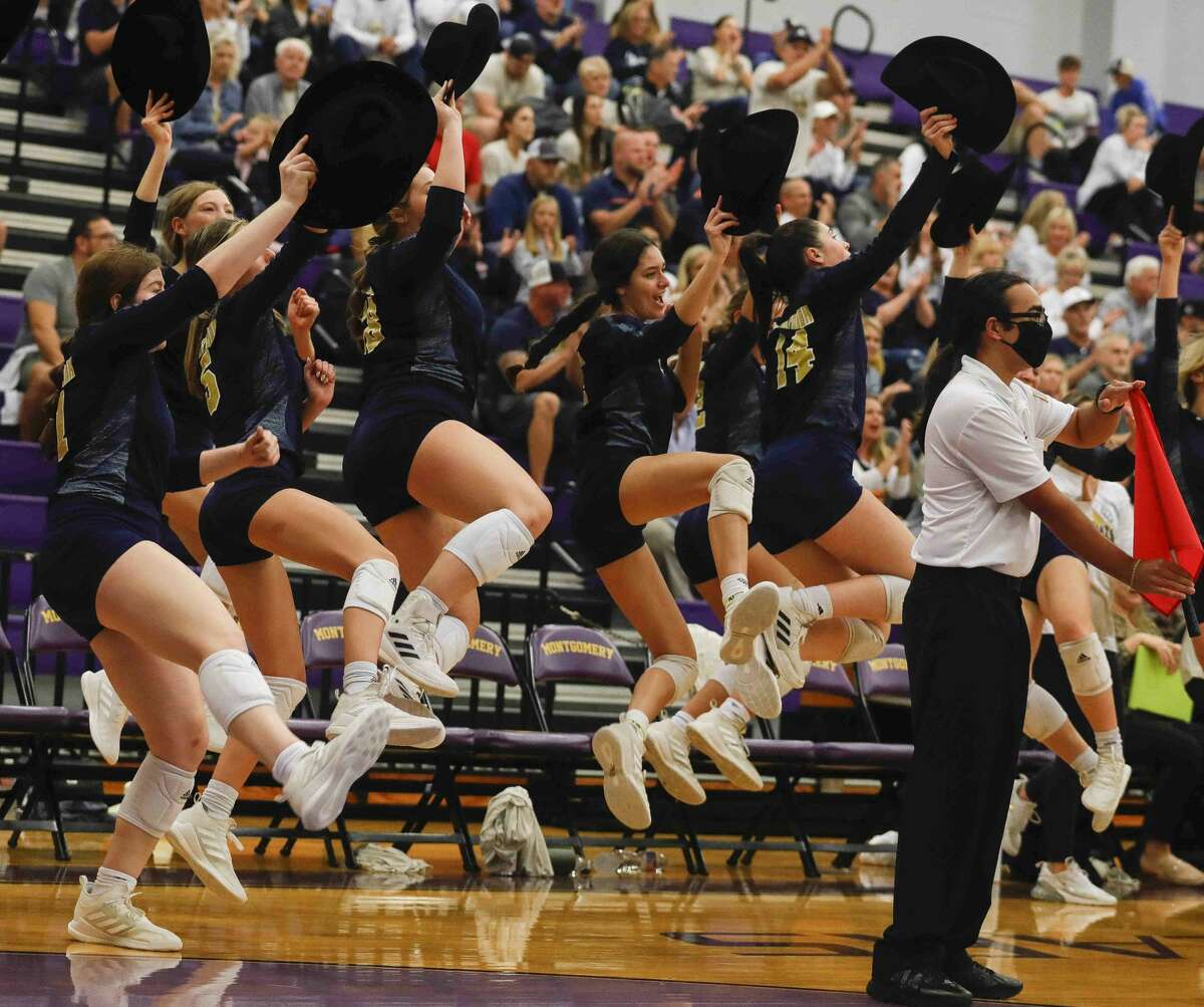 Lake Creek players celebrate back-to-back aces with cowboy hats in hand during the first set of a Region III-5A bi-district volleyball playoff match at Montgomery High School, Tuesday, Nov. 2, 2021, in Montgomery.