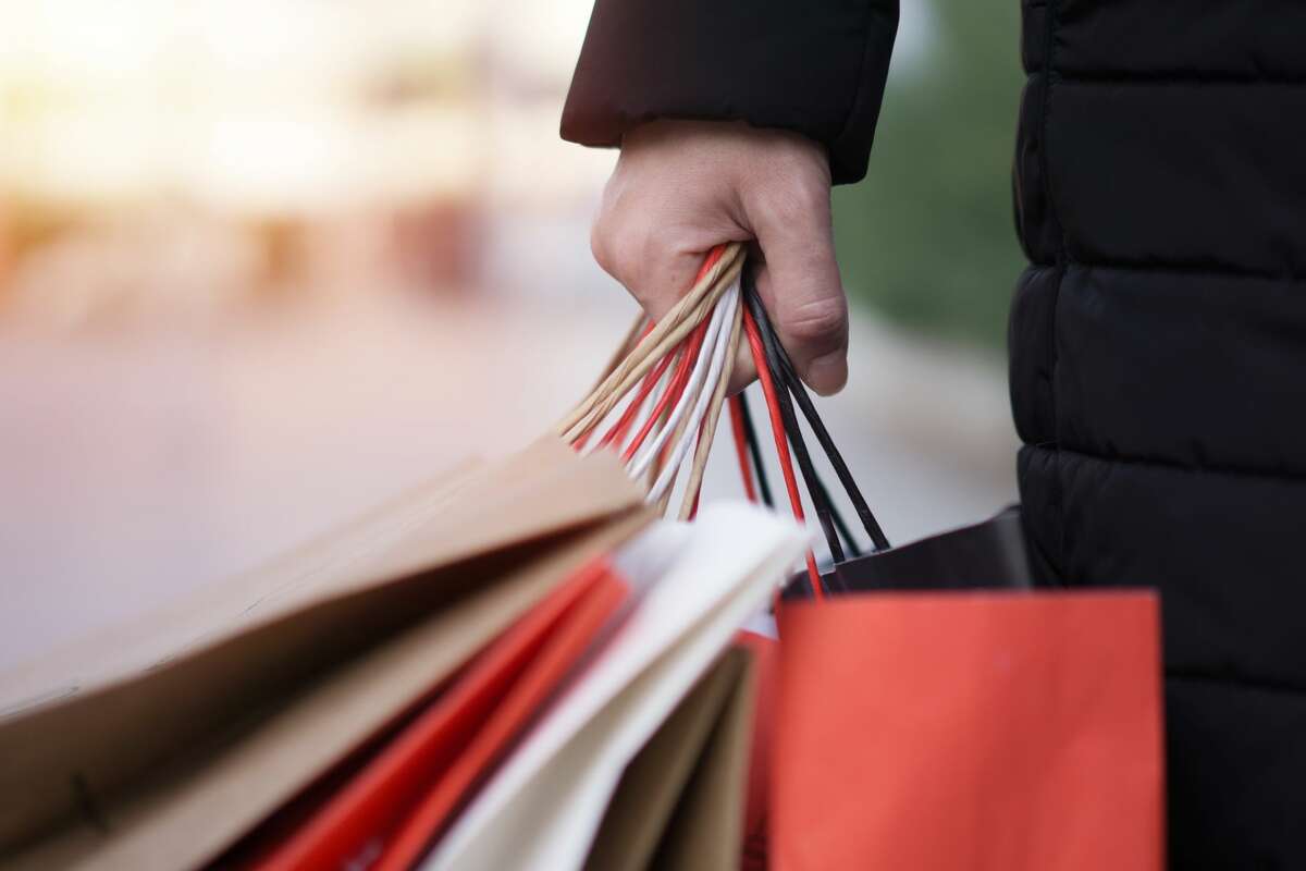 A file image of a woman holding several shopping bags. 