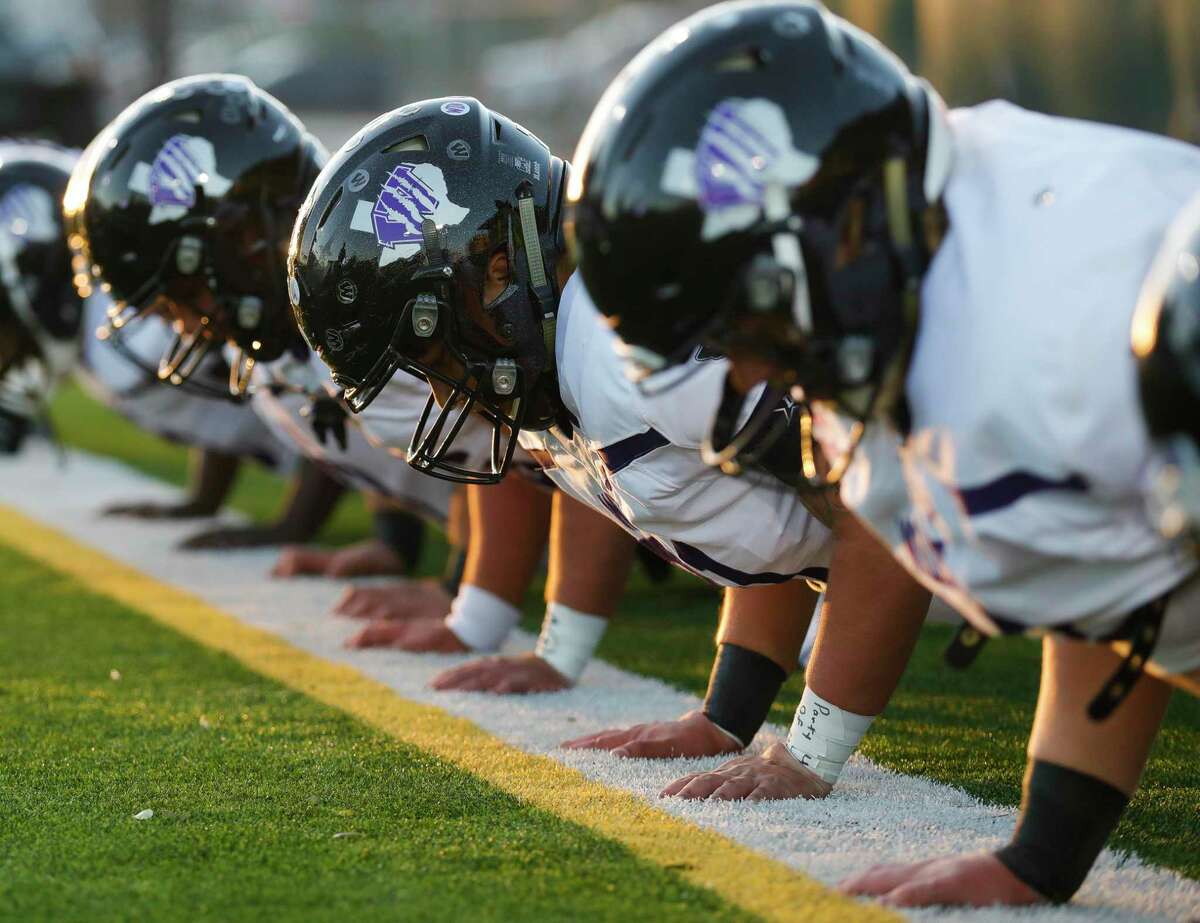 Willis offensive linmen do pushups before a high school football game at Woodforest Bank Stadium, Thursday, Oct. 28, 2021, in Shenandoah.