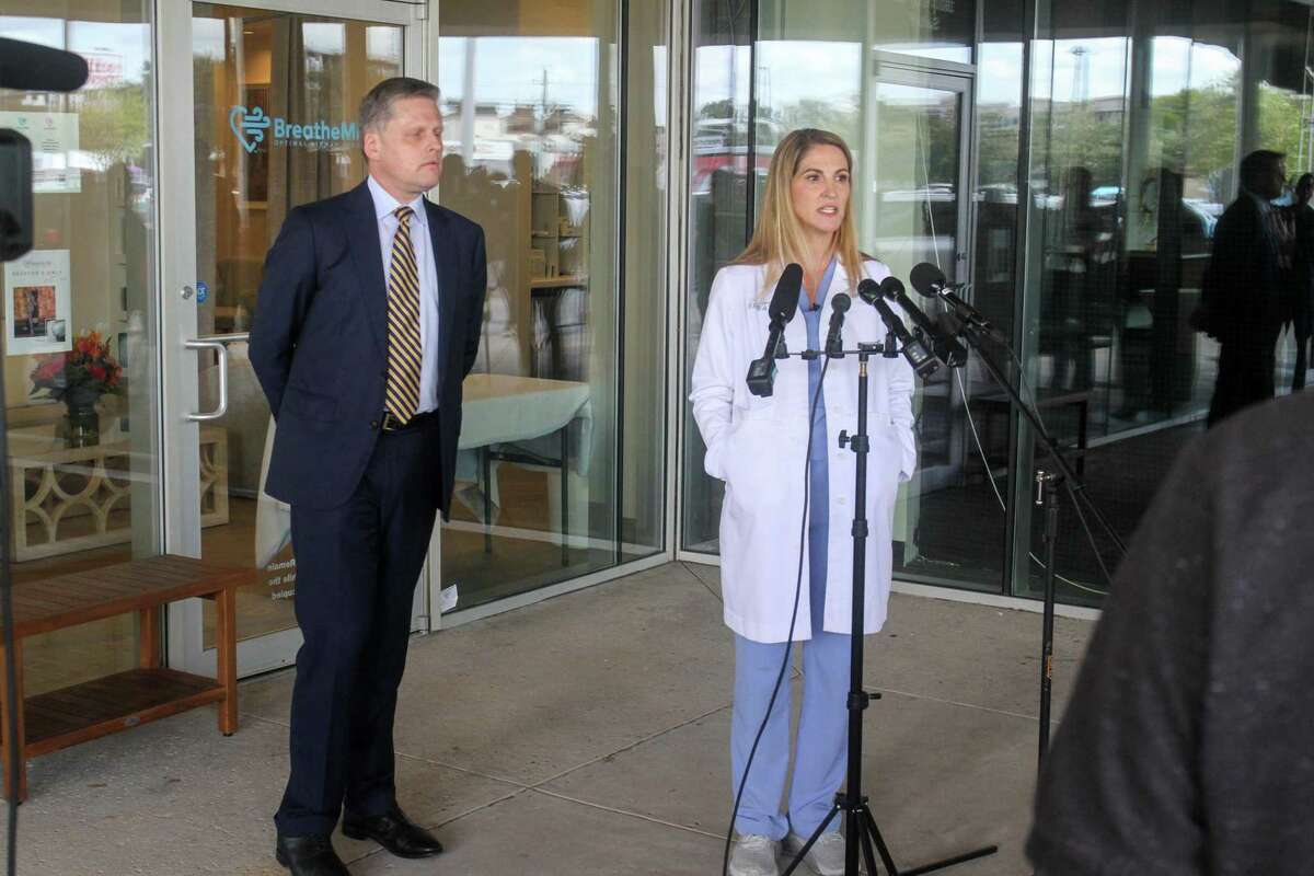 Attorney Steve Mitby and Dr. Mary Bowden, an ENT whose hospital privileges were suspended from Houston Methodist earlier this week for spreading COVID misinformation on social media, during a press conference at her office in Houston.
