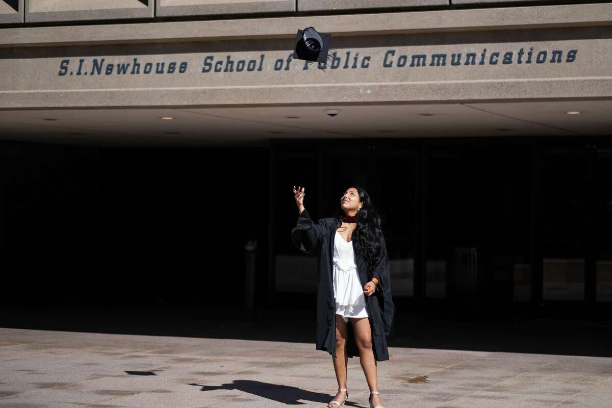 Times Union reporter Shrishti Mathew tossing her cap at her graduation from the Newhouse School at Syracuse University. (Credits: Emily Kenny)