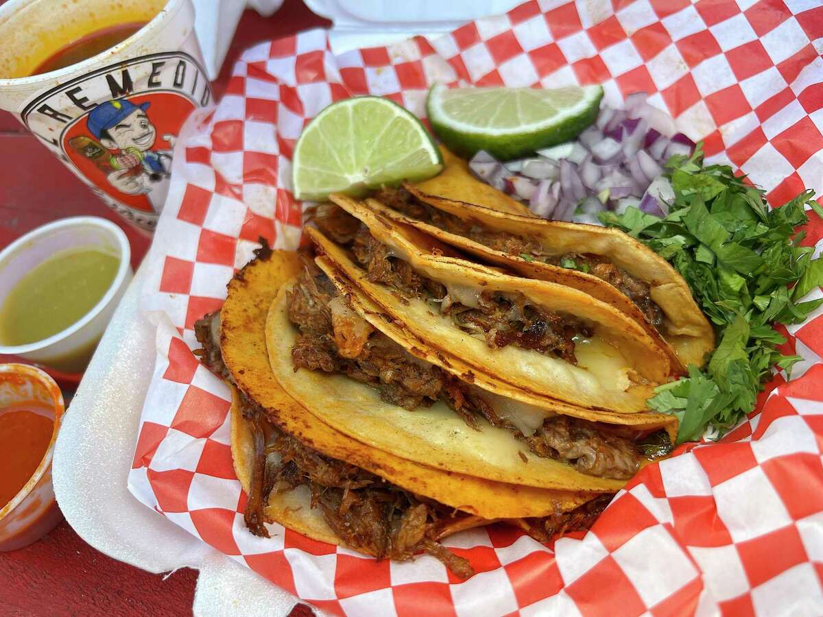 Birria tacos with mozzarella cheese come four to an order with a dipping sauce called consommé broth at El Remedio, a taco trailer specializing in birria de res on Culebra Road.