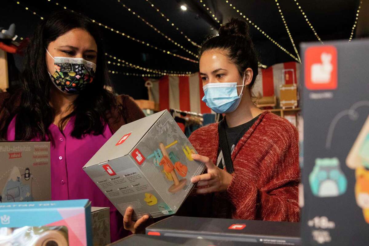 Gina M. Contreras (left) and Victoria Nonaca shop for gifts at Tantrum, a toy store in San Francisco. Parents shopping online should be vigilant about toys that have been recalled for safety reasons.
