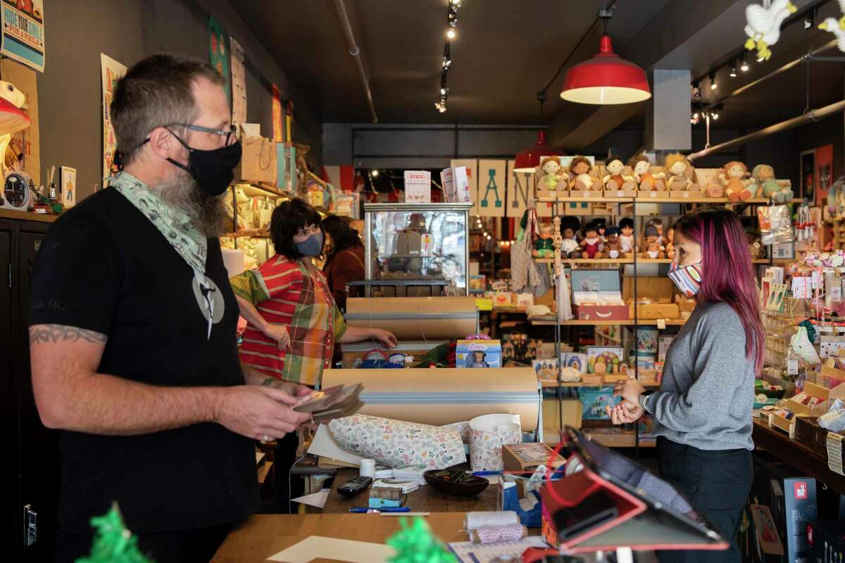 Staffers work to fill multiple online orders at Tantrum, a toy store in the Inner Richmond neighborhood of San Francisco, on Tuesday. Christmas shopping is changing this year — consumers are being advised to shop early because of supply chain shortages.